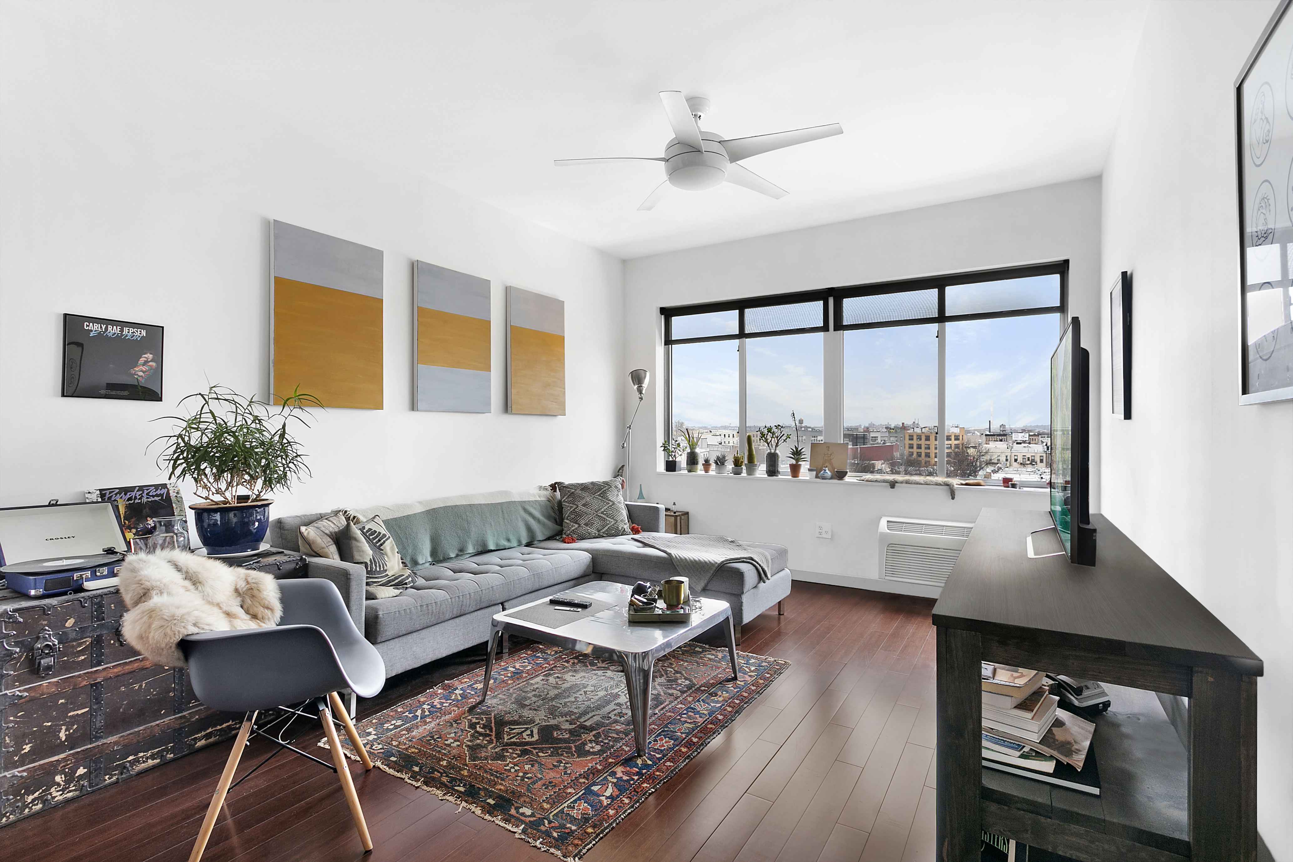 a living room with furniture and a large window