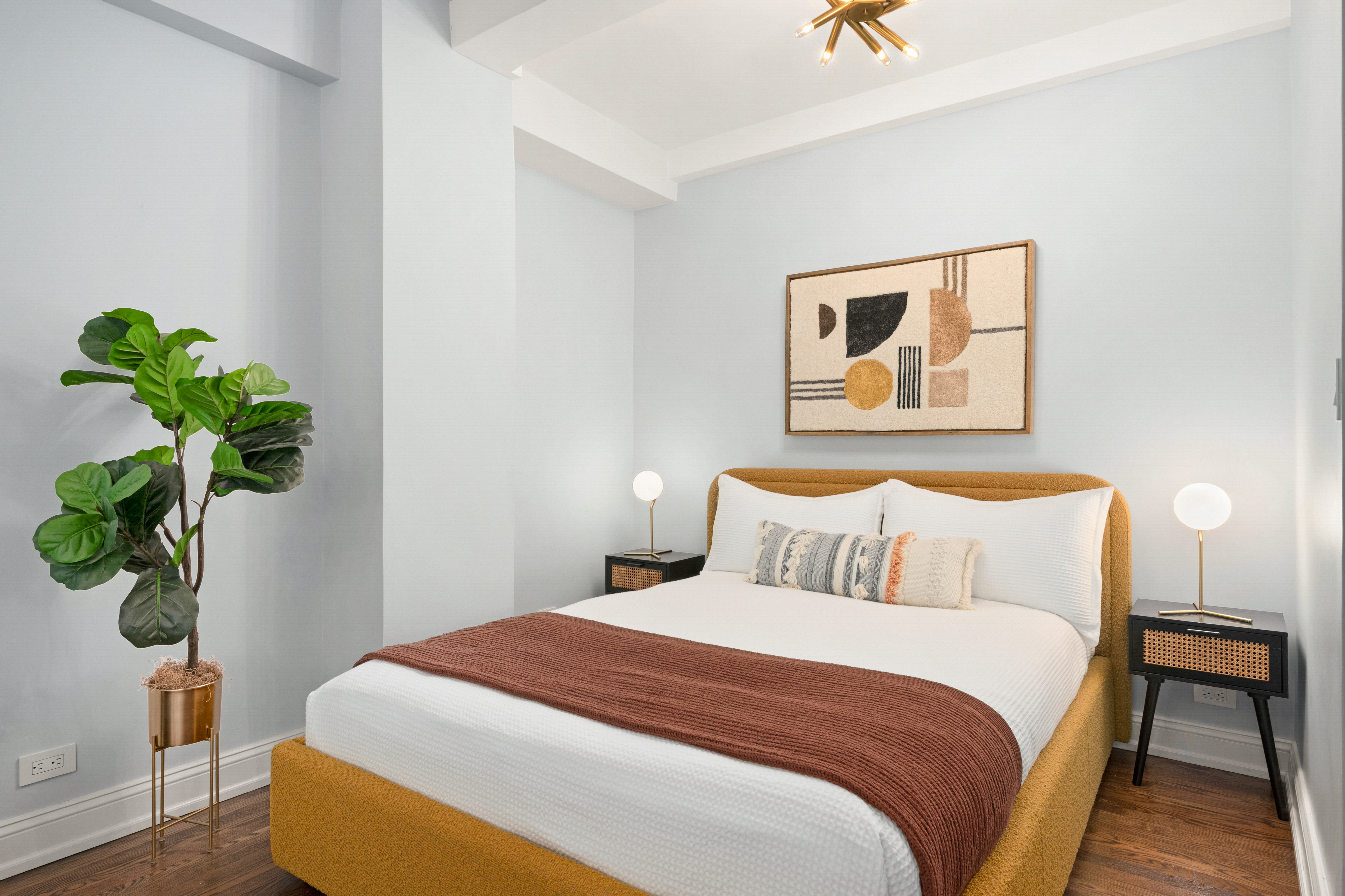 465 West 23rd Street, Unit 2G Manhattan, NY 10011 - Photo 4 of 11 a bedroom with a bed and a potted plant