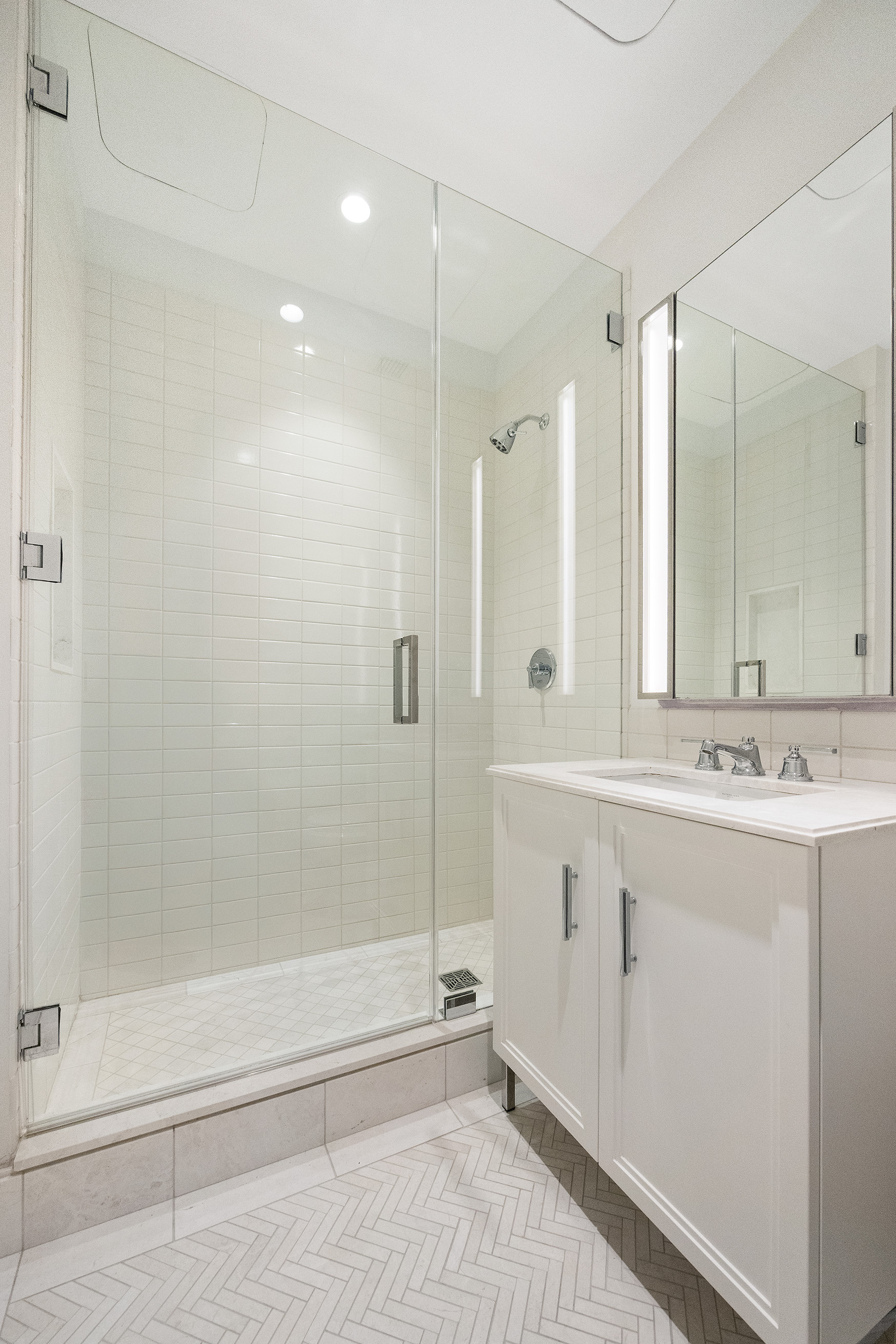 100 Barclay Street, Unit 21AD Manhattan, NY 10007 - Photo 22 of 37 a bathroom with a shower sink and mirror
