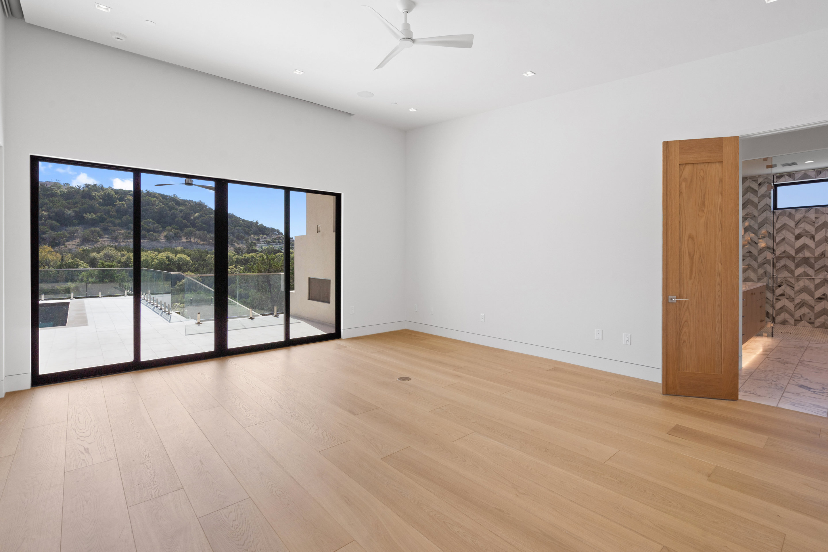 1905 Hallam Drive Austin, TX 78746 - Photo 19 of 39 wooden floor in an empty room with a window