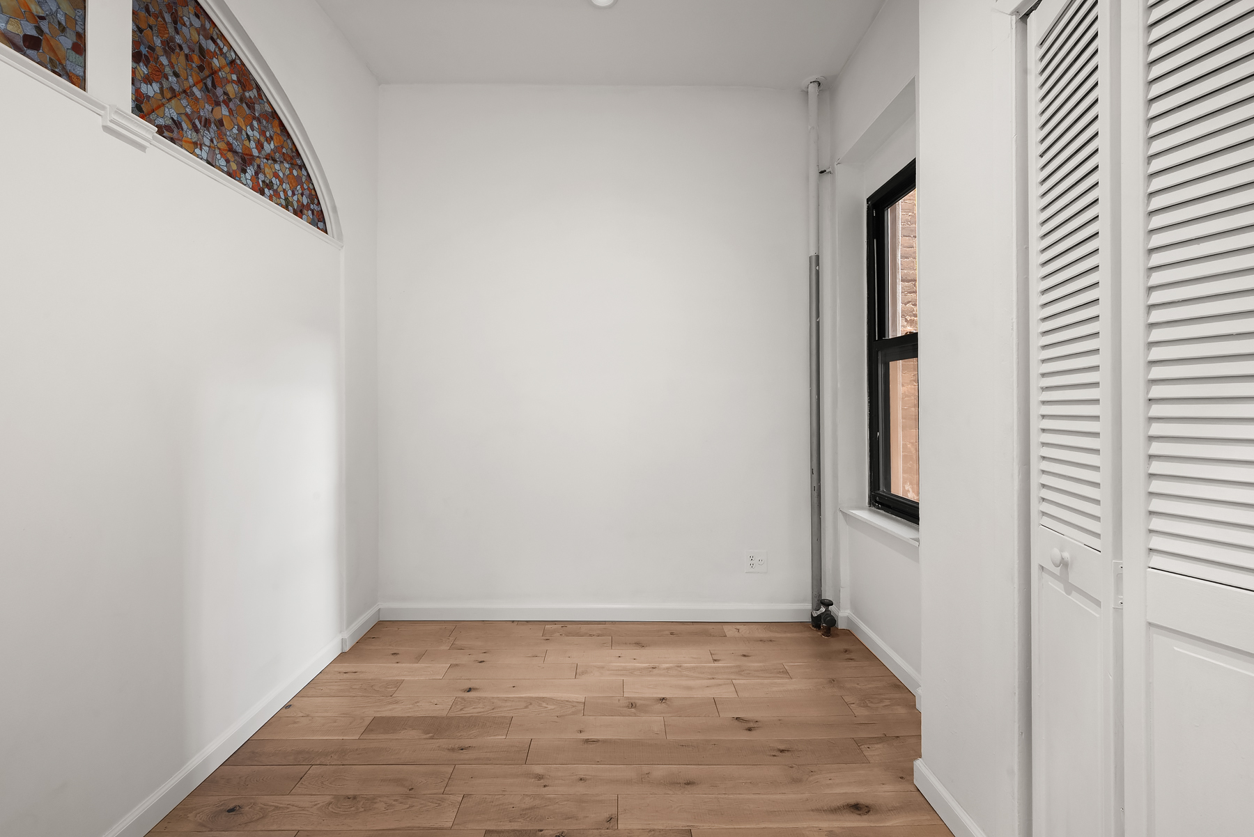 786 9th Avenue, Unit 2R Manhattan, NY 10019 - Photo 6 of 9 a view of a small space with wooden floor and a window