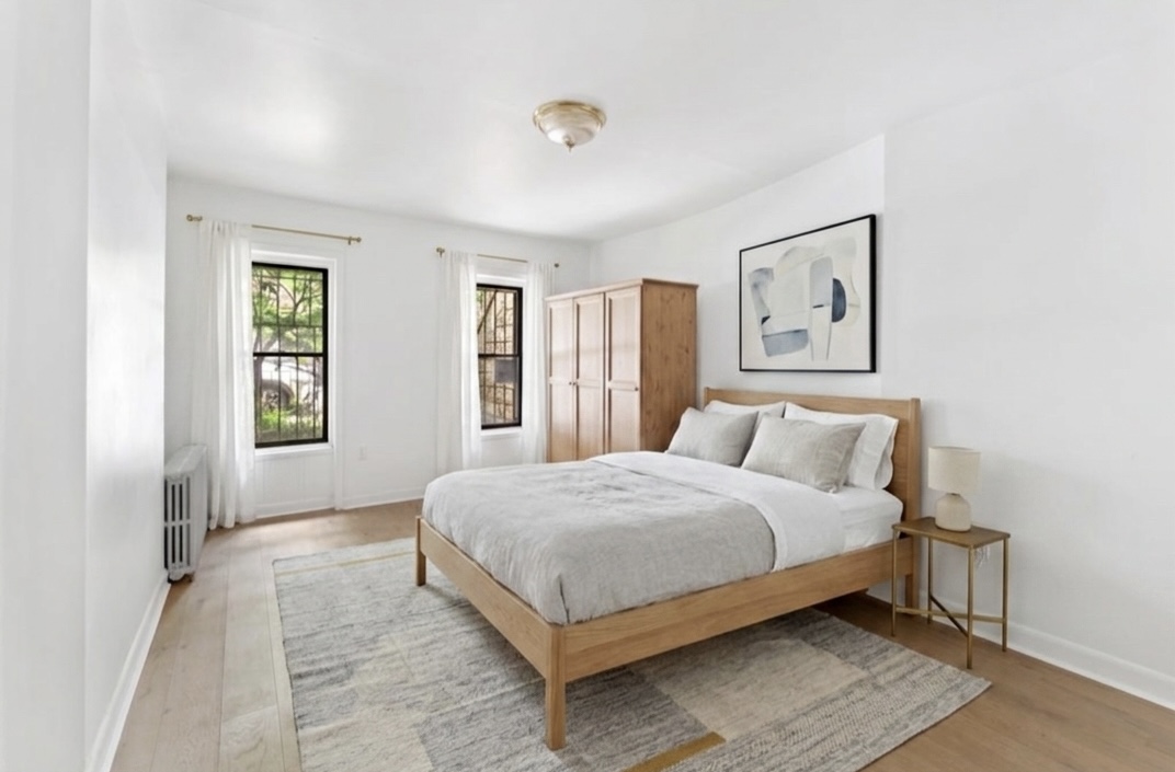 281 6th Street, Unit 1 Brooklyn, NY 11215 - Photo 5 of 7 a bedroom with a large bed and a window
