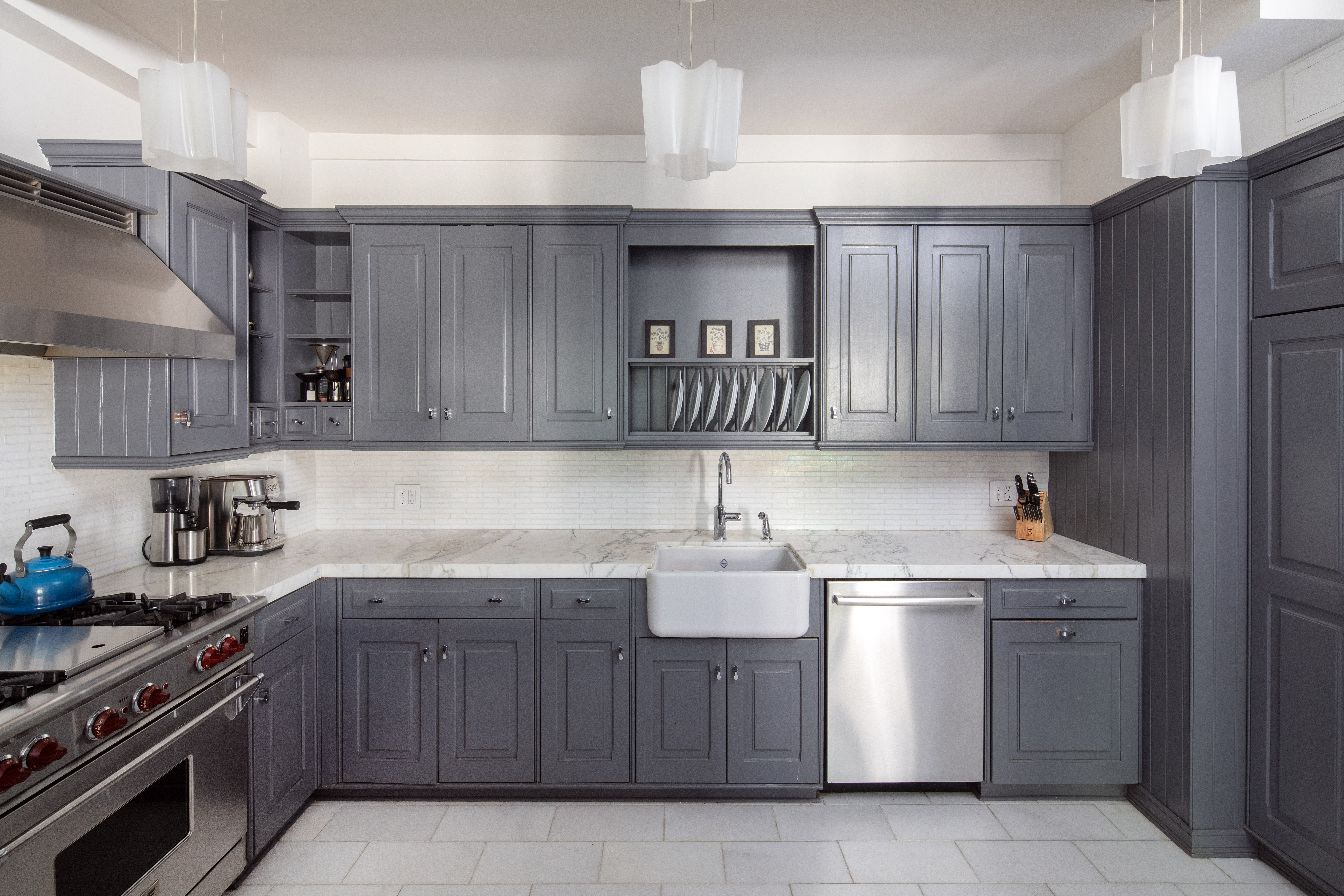 60 West 68th Street, Unit 5B Manhattan, NY 10023 - Photo 4 of 7 a kitchen with a sink stove top oven and cabinets