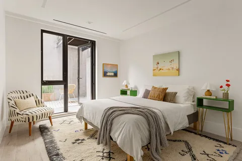 a bedroom with a bed and a painting on the wall