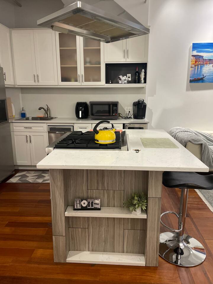 43-45 East 30th Street, Unit 8D Manhattan, NY 10016 - Photo 4 of 11 a kitchen with stainless steel appliances granite countertop a stove and a cabinets