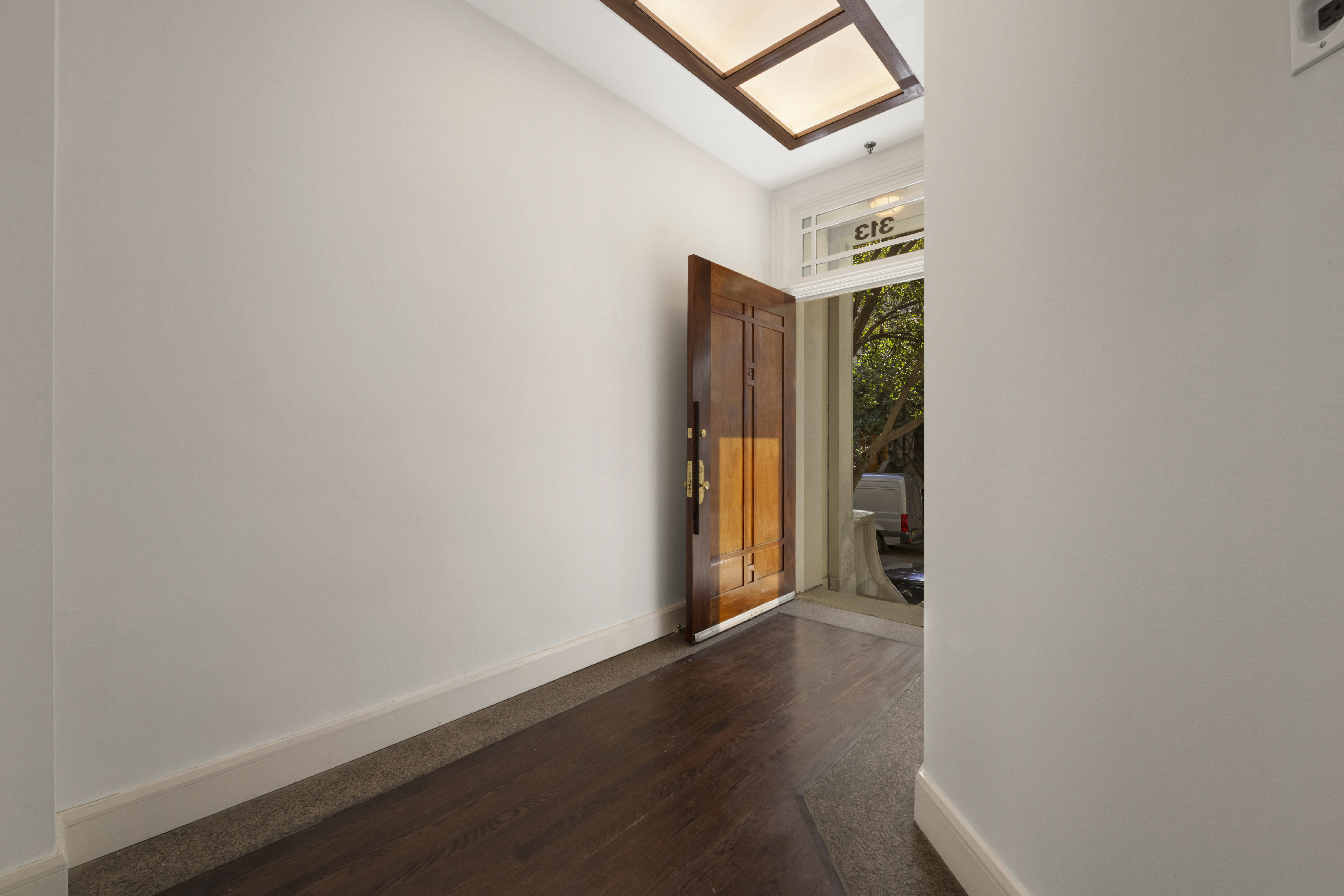 313 West 102nd Street Manhattan, NY 10025 - Photo 34 of 36 a view of an empty room with closet and wooden floor