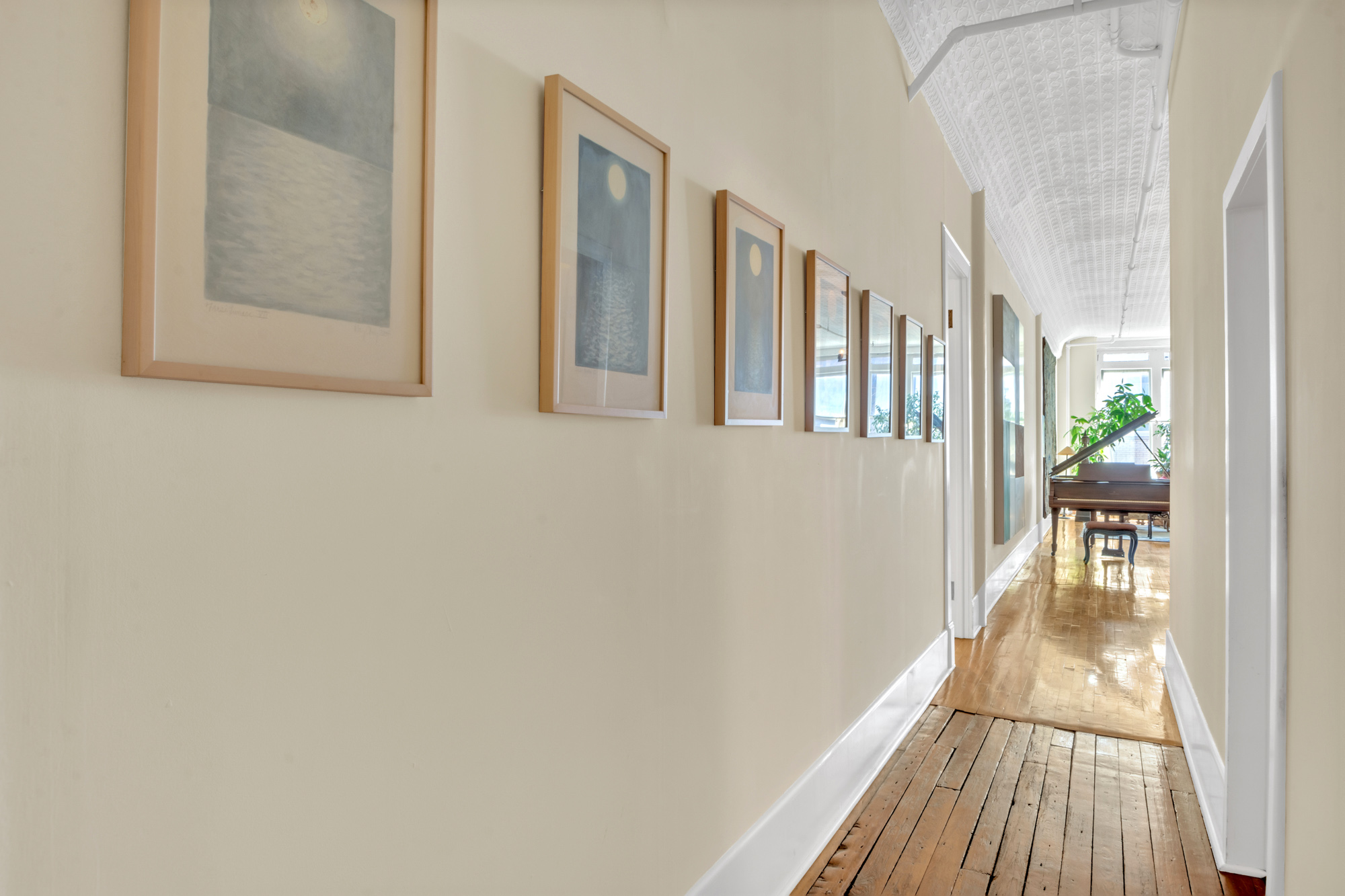 69 Wooster Street, Unit 3 Manhattan, NY 10012 - Photo 9 of 22 a view of a hallway with wooden floor and a bathroom