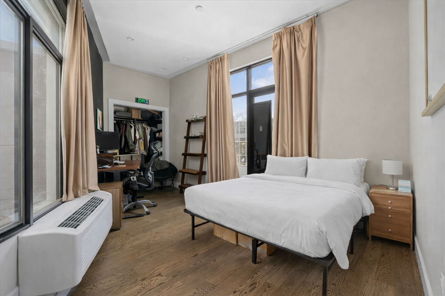 83 Suydam Street, Unit TWOFAMILY Brooklyn, NY 11221 - Photo 3 of 11 a bedroom with a bed and a large window