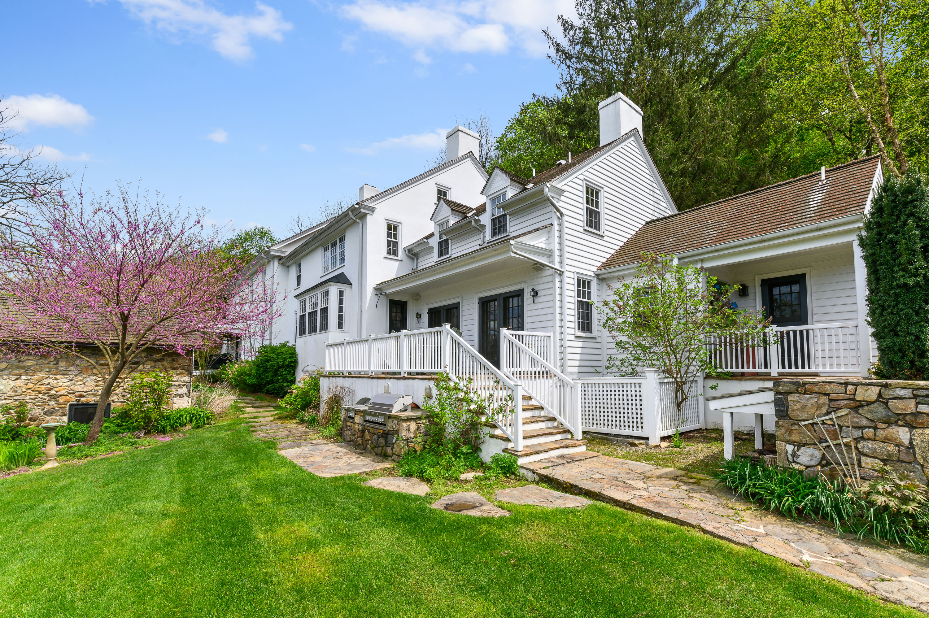 639 Church Road Malvern, PA 19355 - Photo 13 of 32 a front view of a house with a yard and potted plants