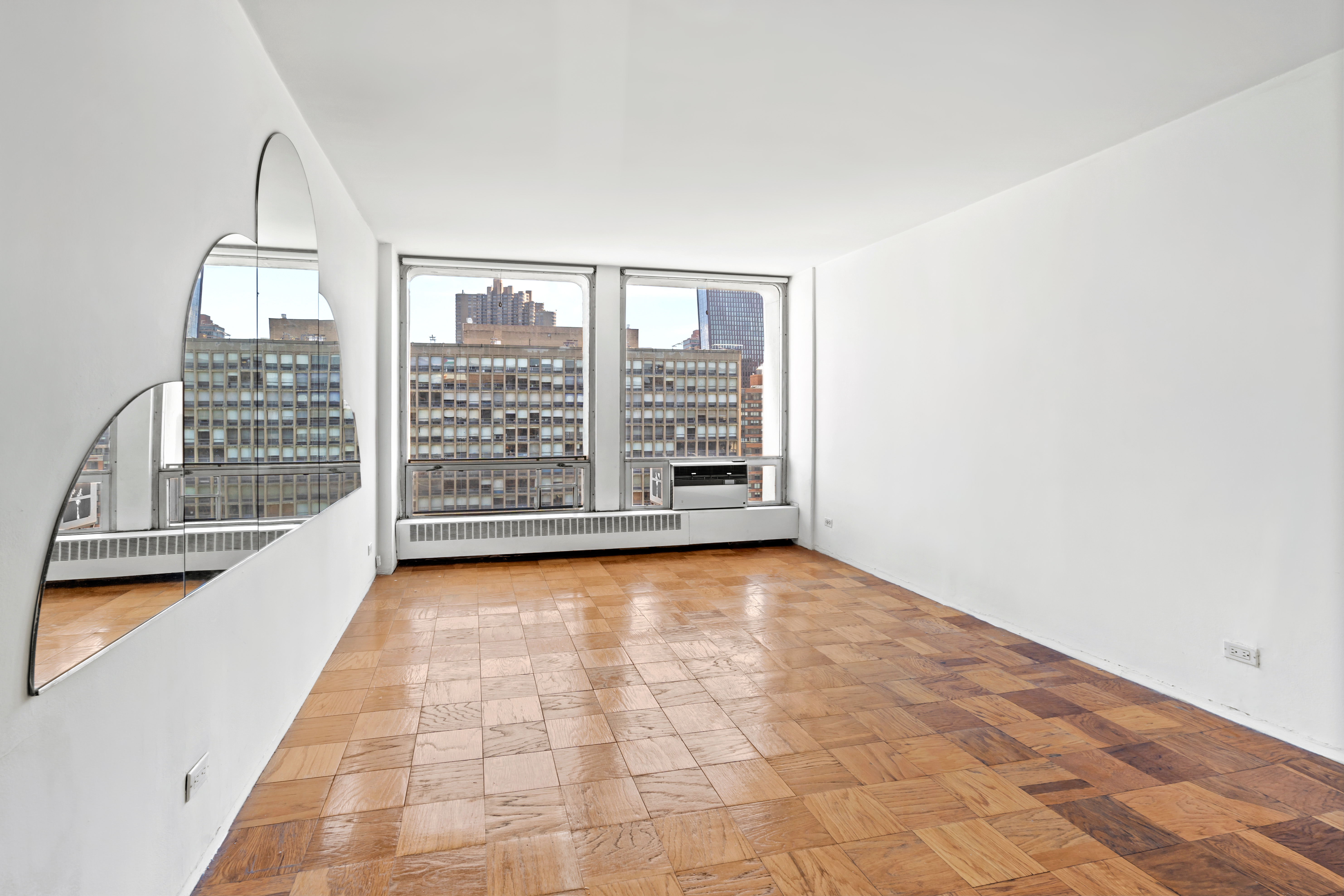 333 East 30th Street, Unit 18N Manhattan, NY 10016 - Photo 8 of 18 wooden floor in an empty room with a window