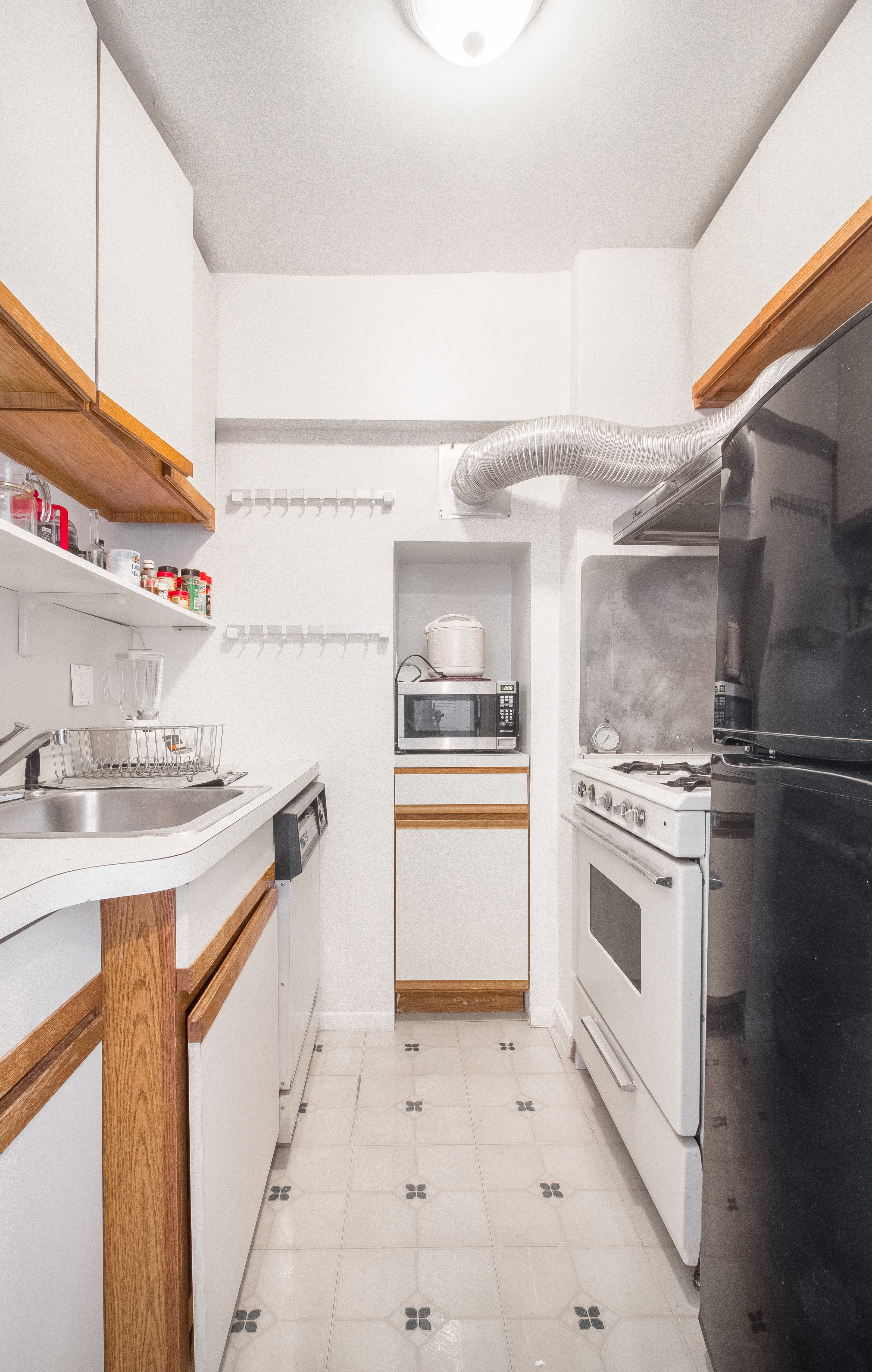 50-15 39th Street, Unit 4C Queens, NY 11104 - Photo 5 of 10 a kitchen with a sink stove and refrigerator