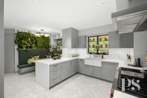 a kitchen with a sink stove and cabinets