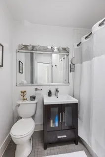 a bathroom with a sink toilet and mirror