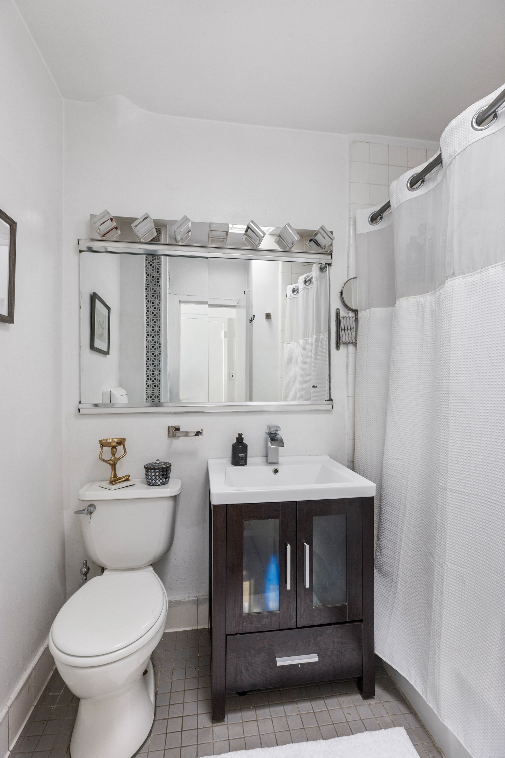 430 East 77th Street, Unit 7C Manhattan, NY 10075 - Photo 5 of 7 a bathroom with a sink toilet and mirror