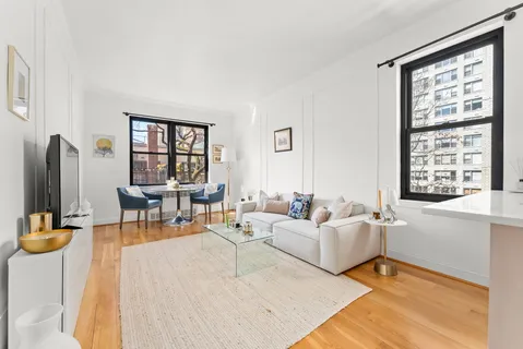 a living room with furniture and large window