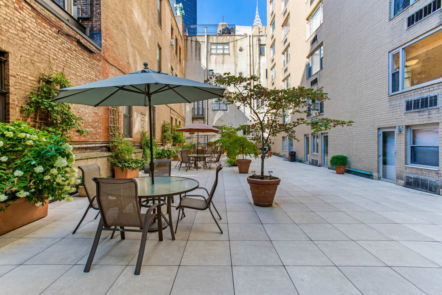 310 Lexington Avenue, Unit 15A Manhattan, NY 10016 - Photo 13 of 17 a view of patio with chairs and potted plants