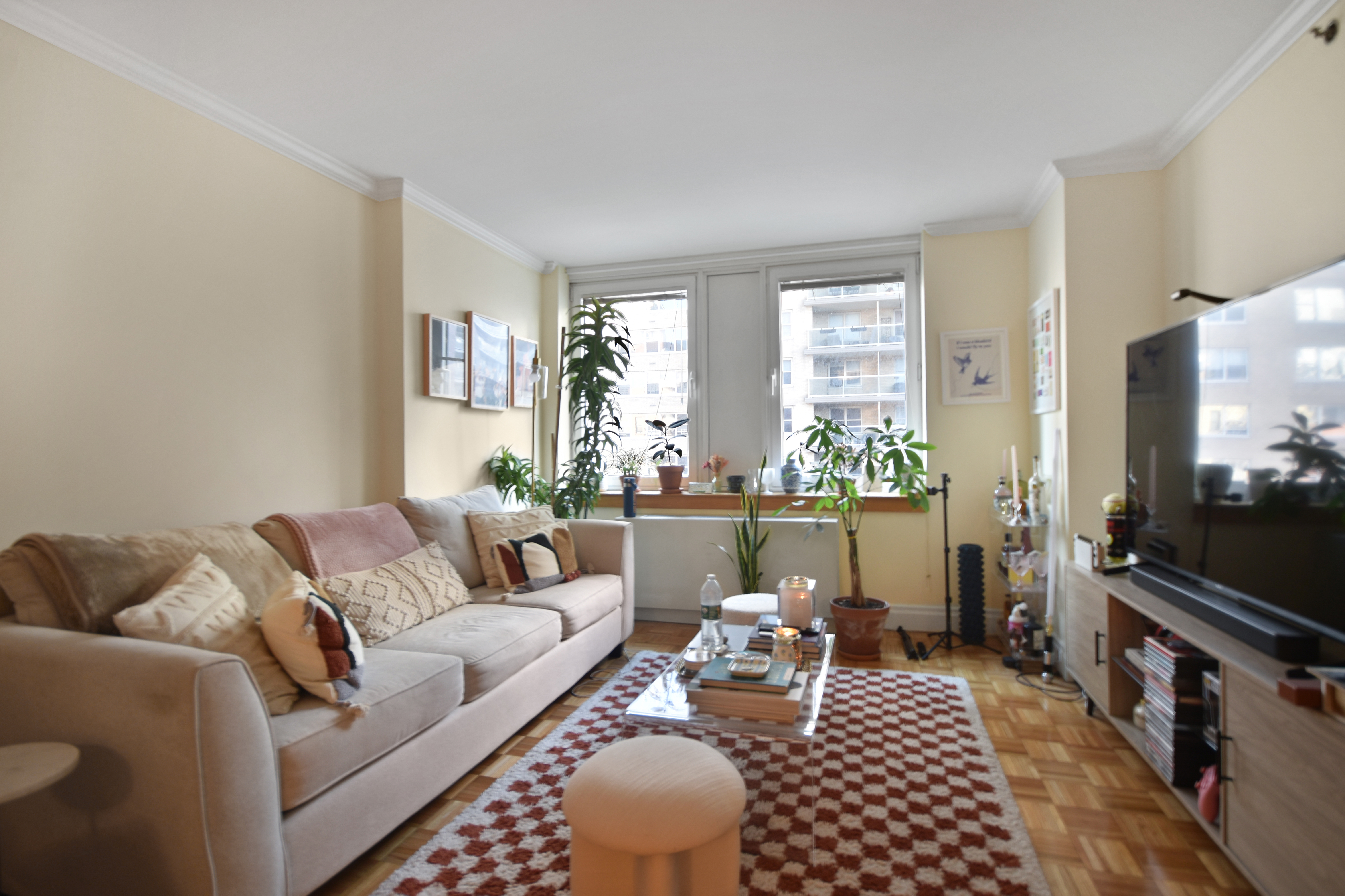 404 East 76th Street, Unit 4A Manhattan, NY 10021 - Photo 2 of 6 a living room with furniture and a flat screen tv