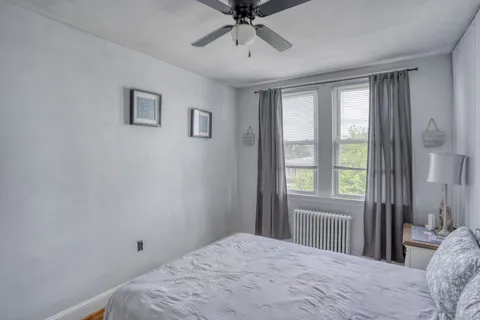 a bedroom with a bed and a window