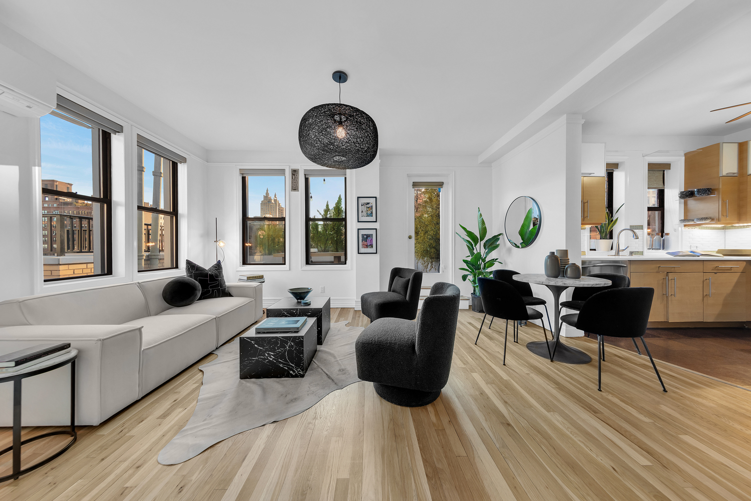 55 West 95th Street, Unit PHE Manhattan, NY 10025 - Photo 2 of 11 a living room with furniture a large window and a clock