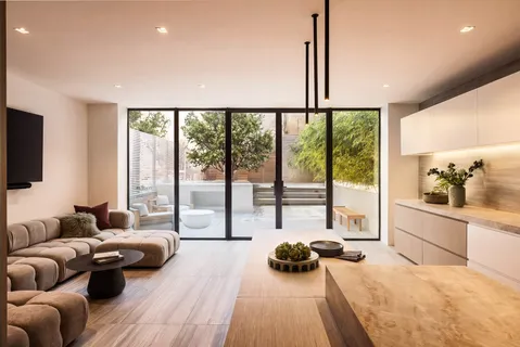 a large bedroom with furniture and a large window