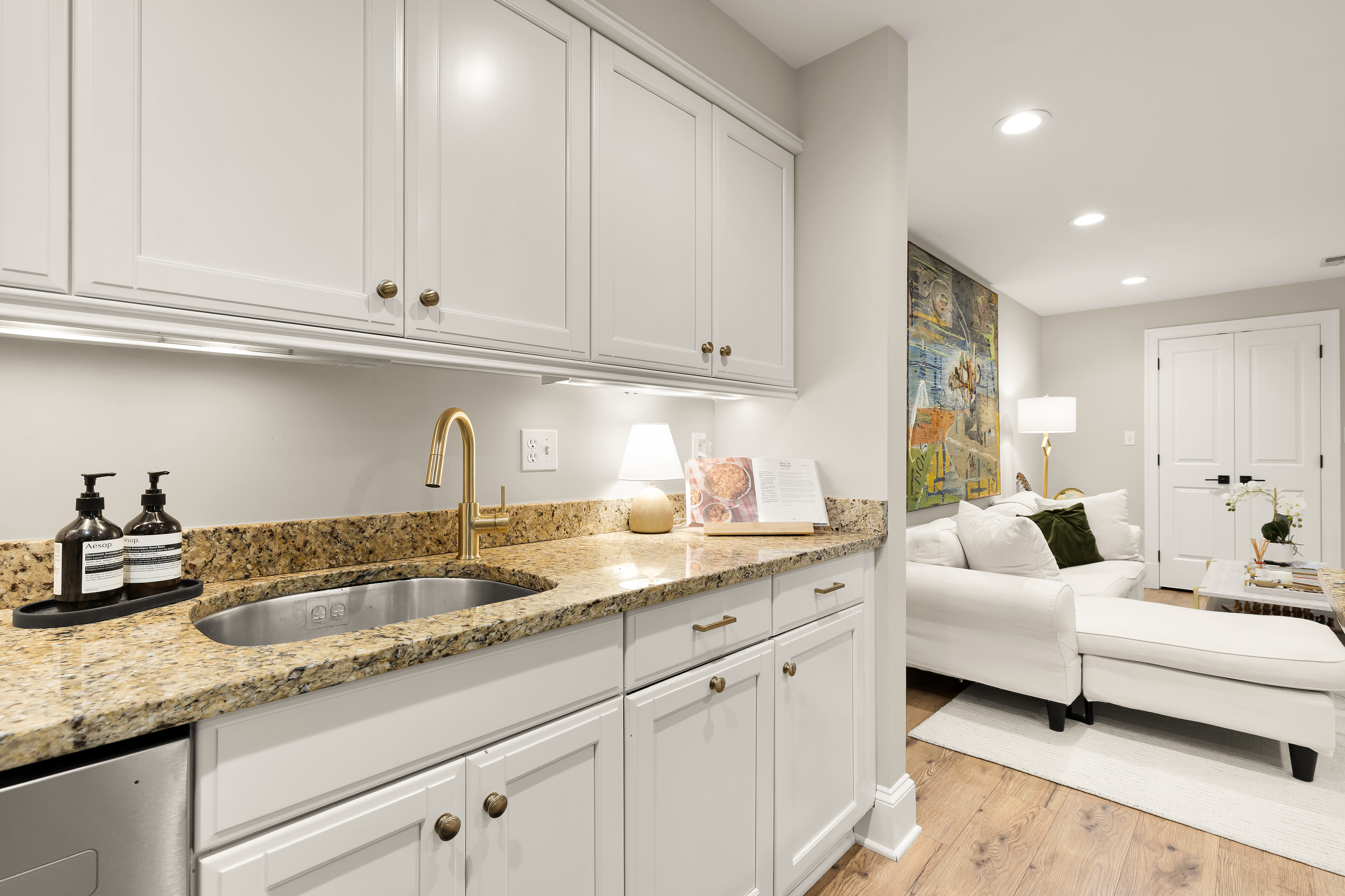 1354 Kenyon Street Northwest, Unit G Washington, DC 20010 - Photo 14 of 35 a kitchen with granite countertop white cabinets and sink