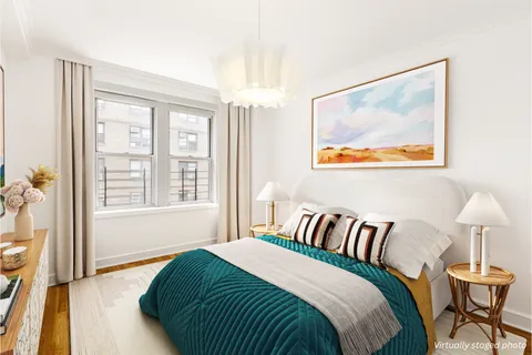 a bedroom with a bed and a lamp next to a window