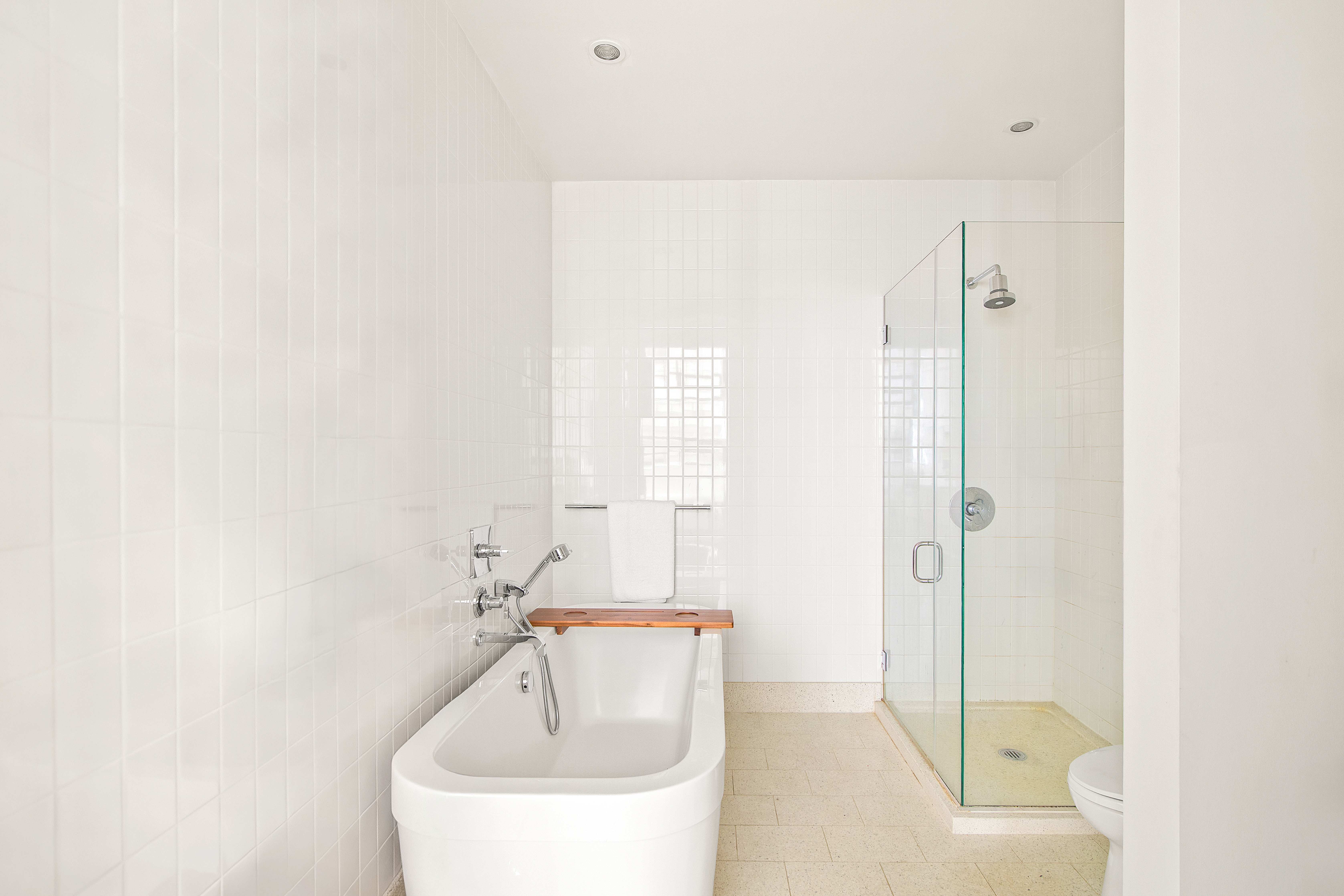 360 Furman Street, Unit 443 Brooklyn, NY 11201 - Photo 5 of 15 a bathroom with a bathtub and a shower
