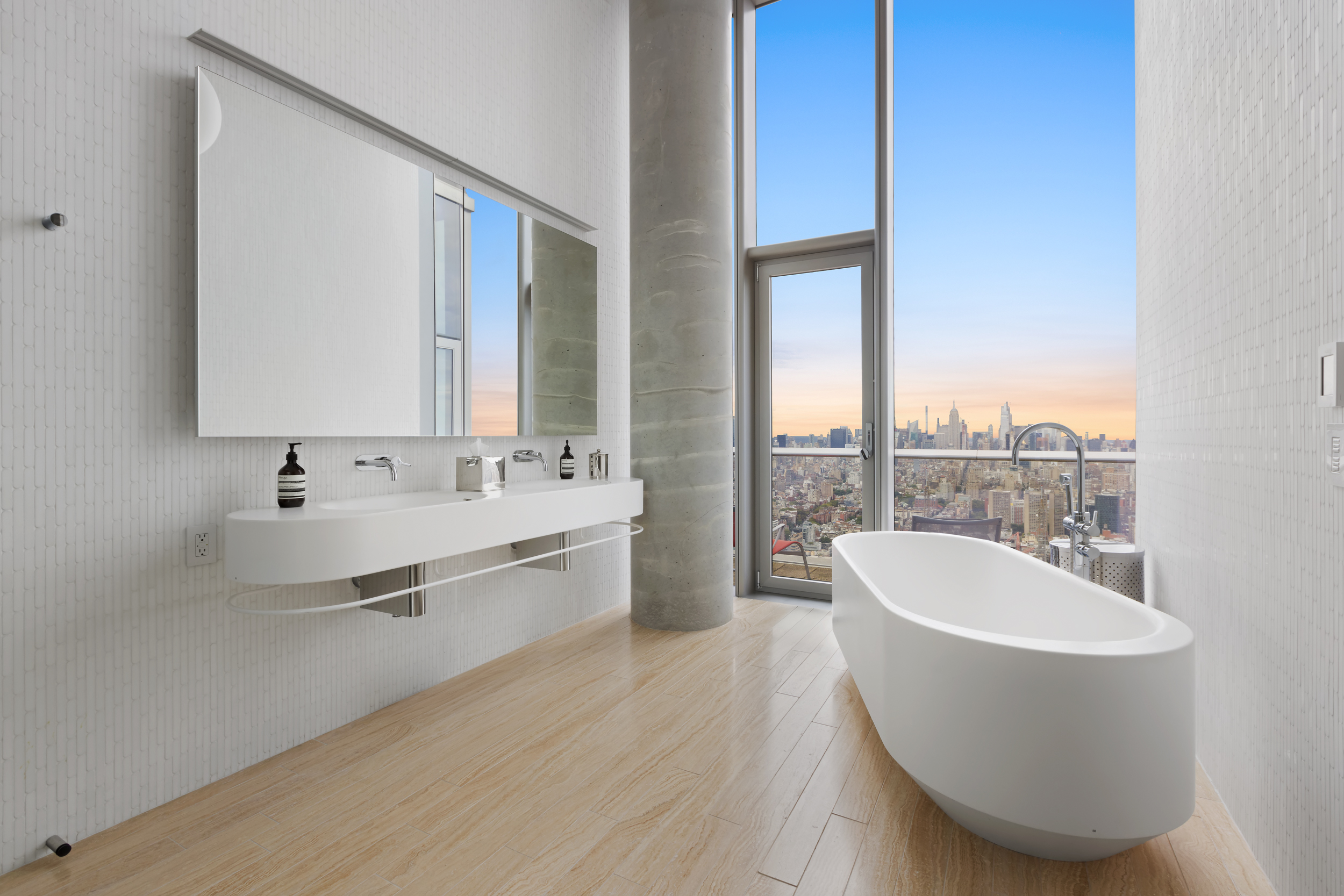 56 Leonard Street, Unit PH52A Manhattan, NY 10013 - Photo 13 of 24 a bathroom with a double vanity sink a mirror and a bathtub