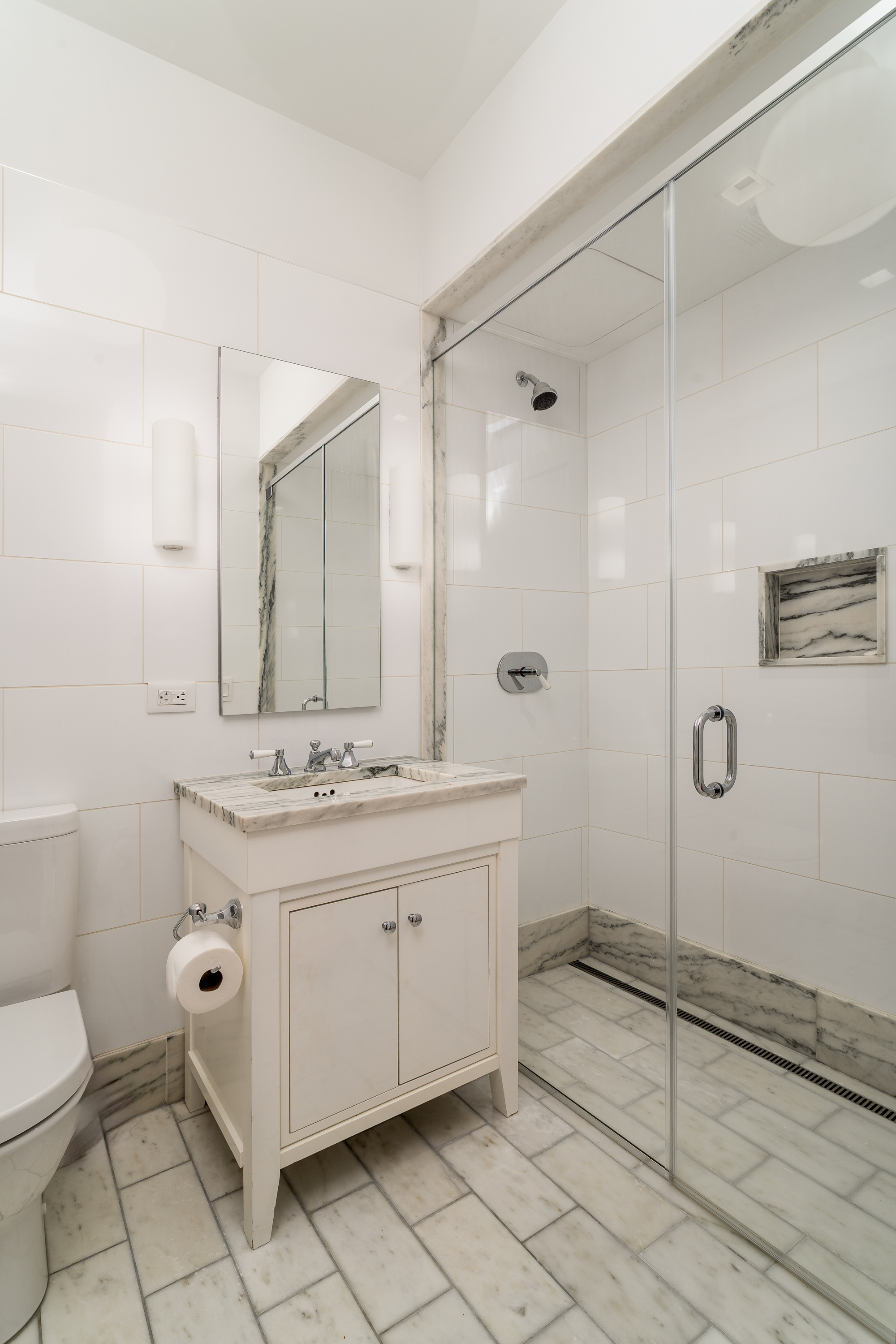 10 Madison Square West, Unit 16F Manhattan, NY 10010 - Photo 13 of 15 a bathroom with a double vanity sink mirror and toilet