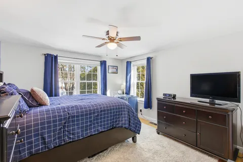 a bedroom with a bed and flat screen tv