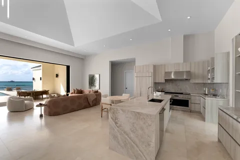 a very nice looking living room with stainless steel appliances furniture a couch and a large window