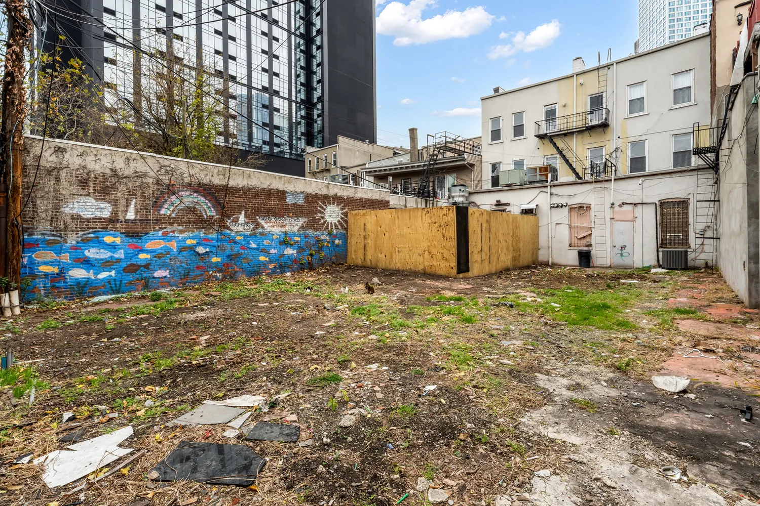 a view of a backyard with wooden fence