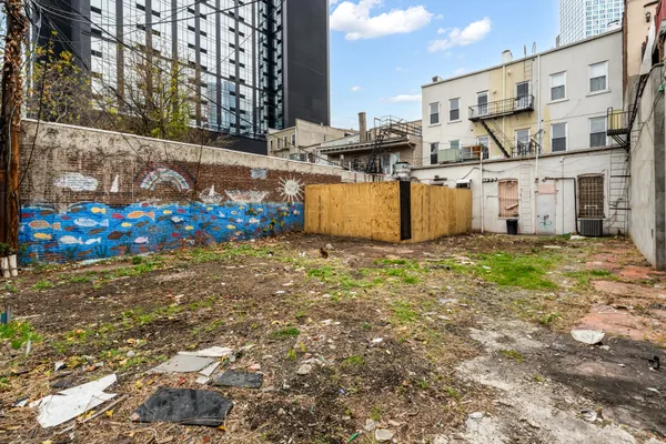 a view of a backyard with wooden fence