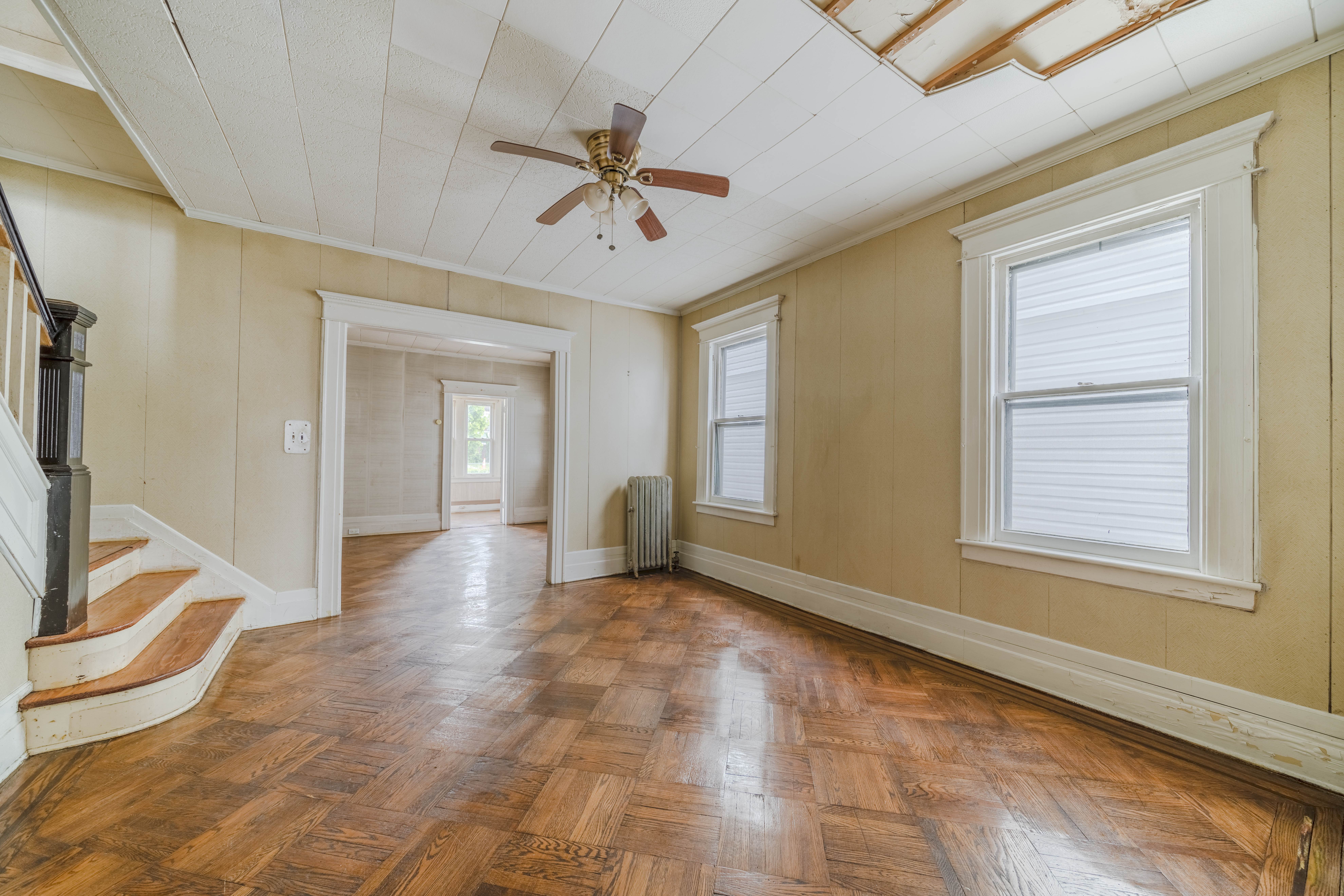100-30 198th Street Queens, NY 11423 - Photo 7 of 15 a view of an empty room with window and chandelier fan