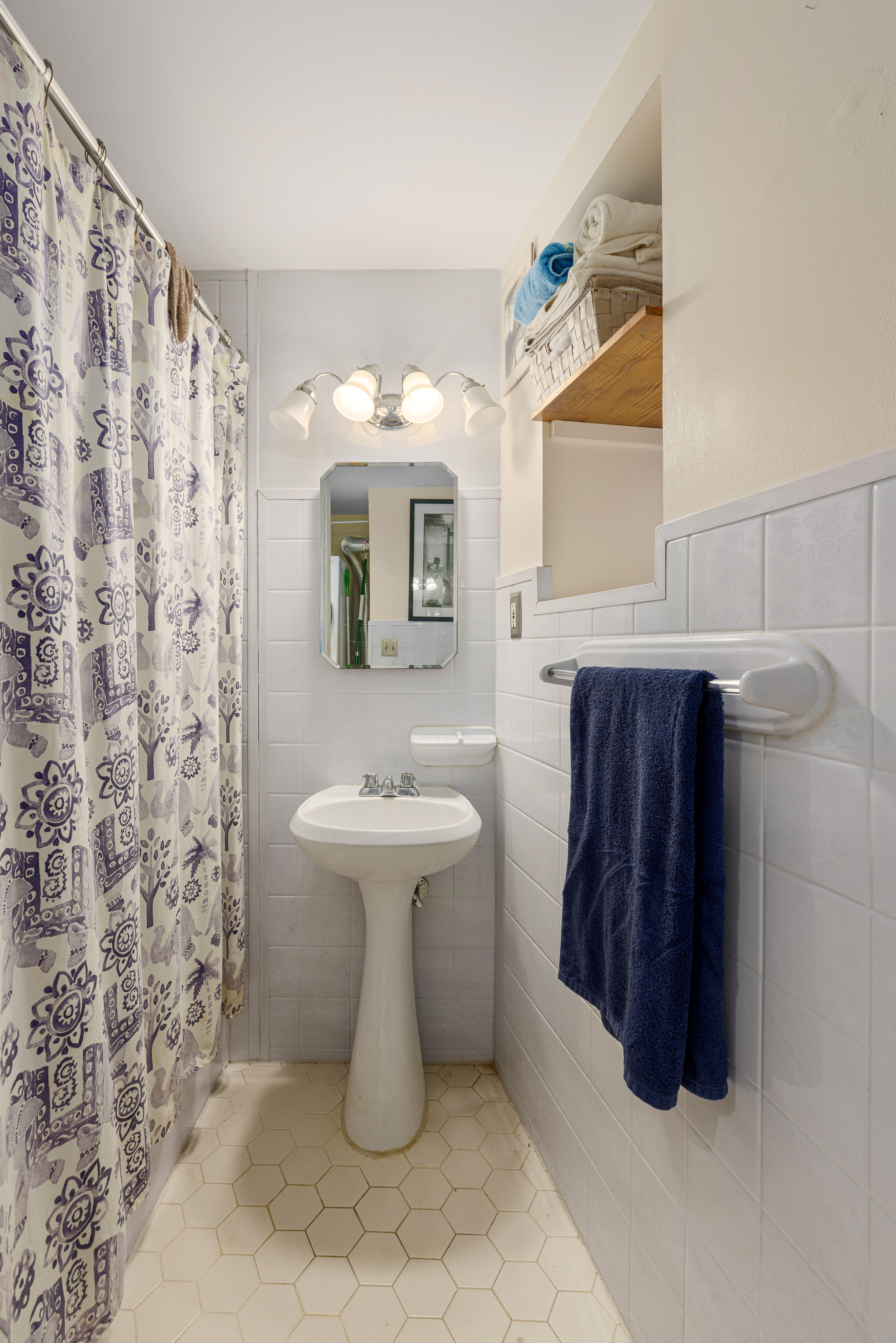 319 East 105th Street, Unit 2F Manhattan, NY 10029 - Photo 4 of 5 a bathroom with a sink a toilet and mirror