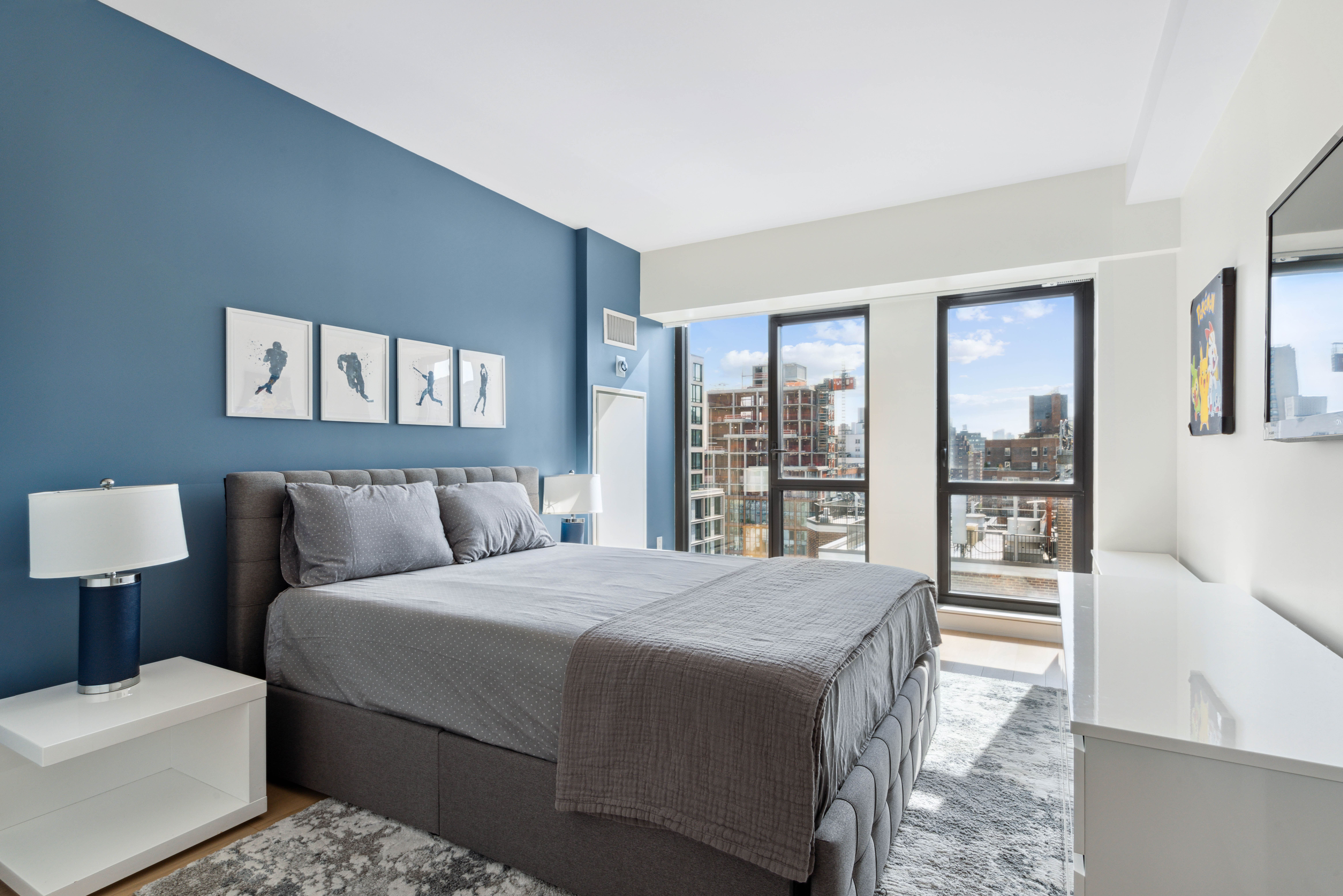 160 East 22nd Street, Unit 18C Manhattan, NY 10010 - Photo 9 of 12 a bedroom with a large bed and a night stand