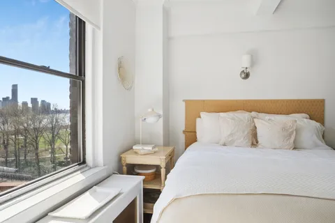 a bedroom with a bed and glass window