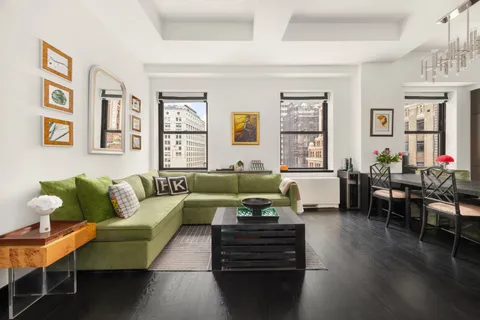 a living room with furniture wooden floor and dining room
