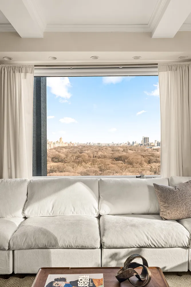 a living room with a couch and a large window