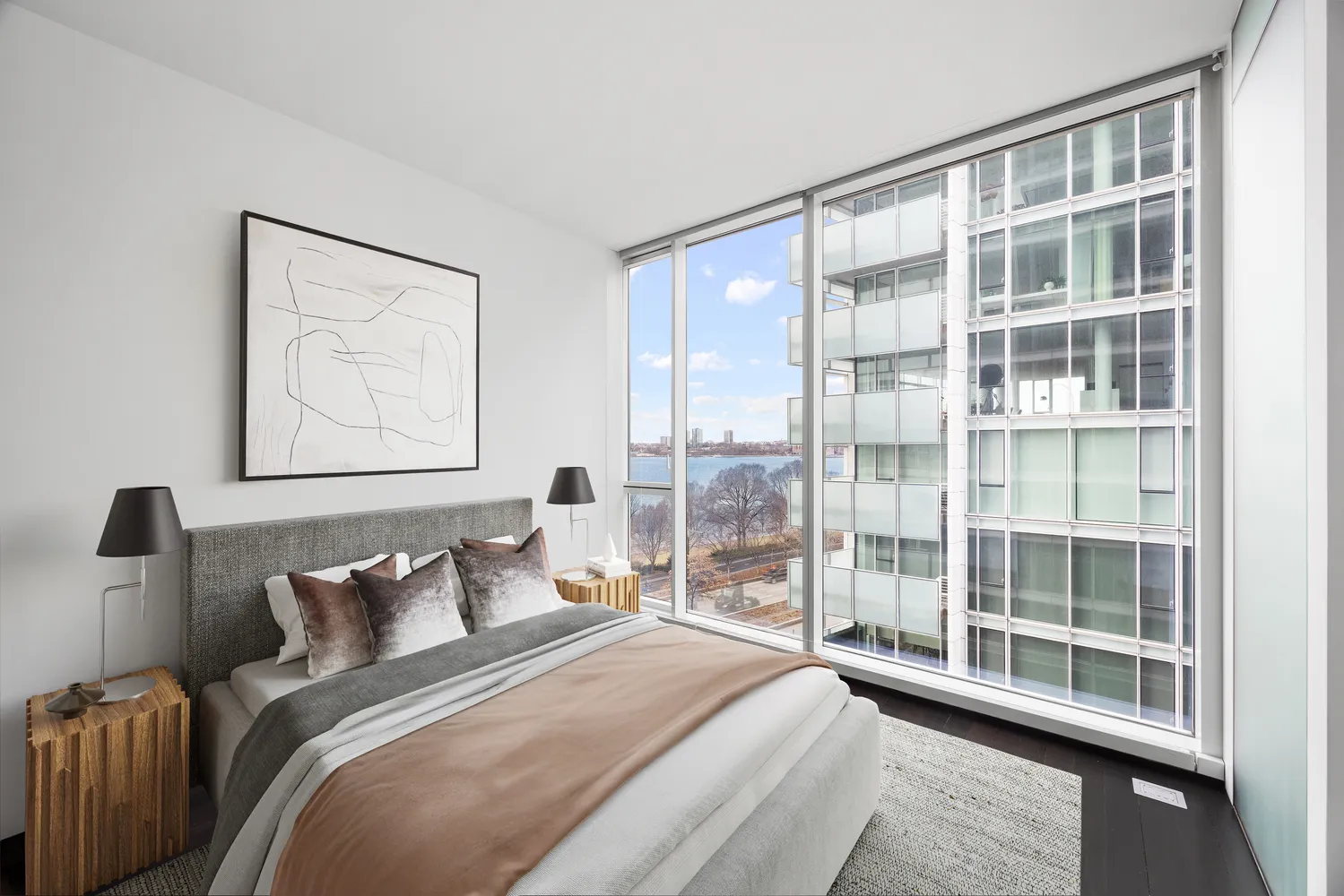 a bedroom with furniture and a large window
