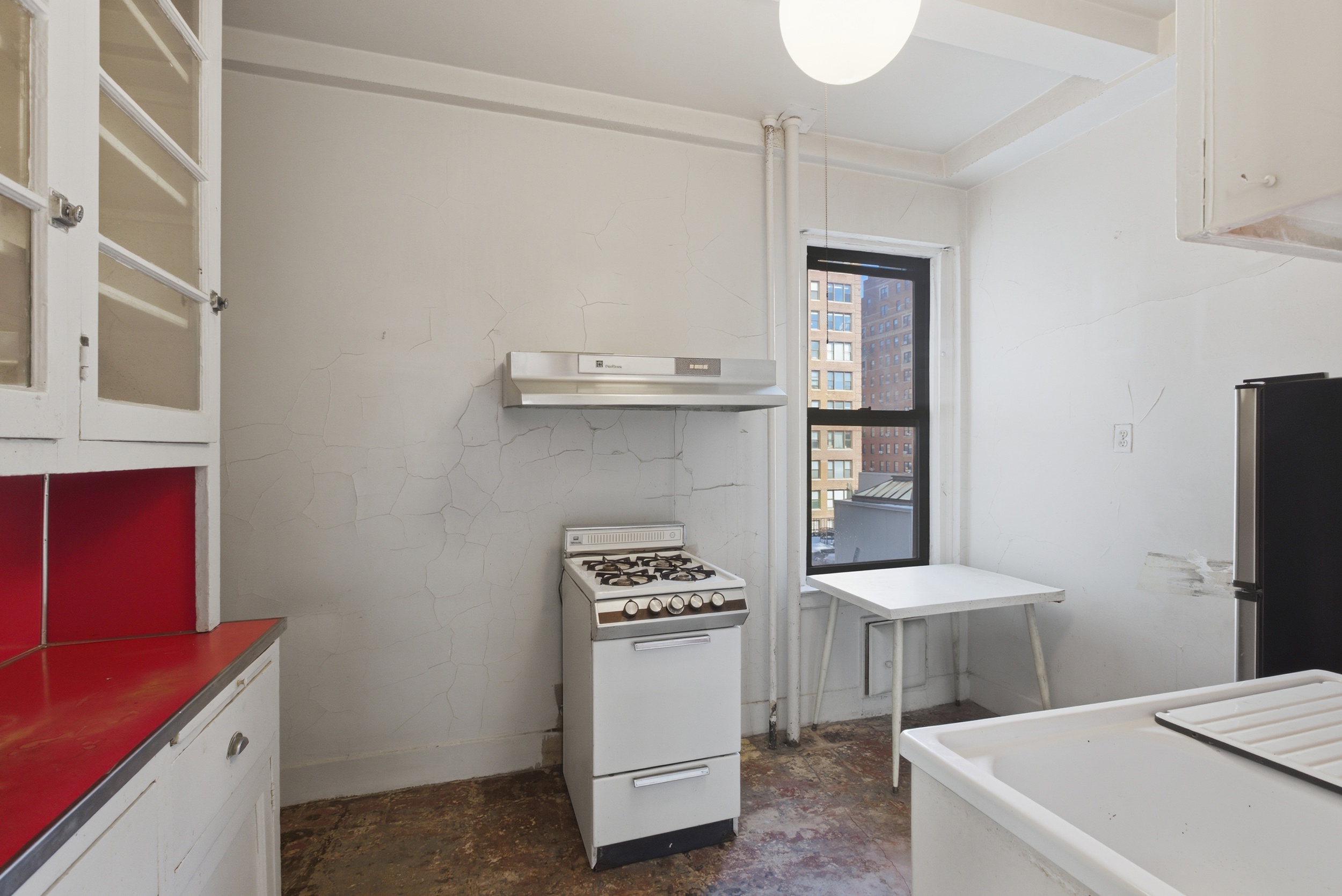 210 West 78th Street, Unit 8C Manhattan, NY 10024 - Photo 10 of 21 a kitchen with a refrigerator and a stove top oven
