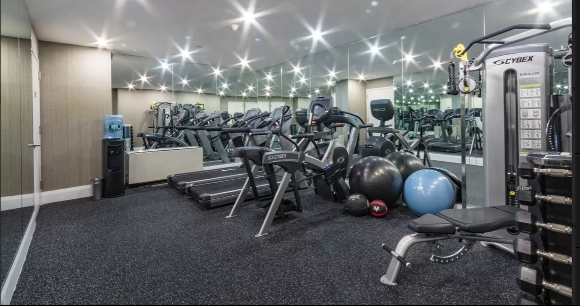 71 Nassau Street, Unit 12C Manhattan, NY 10038 - Photo 14 of 18 a room with lots of gym equipment and windows