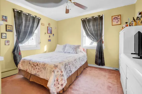 a bedroom with a bed closet and a flat tv screen