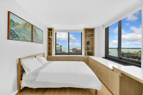 a bedroom with a bed and a night stand