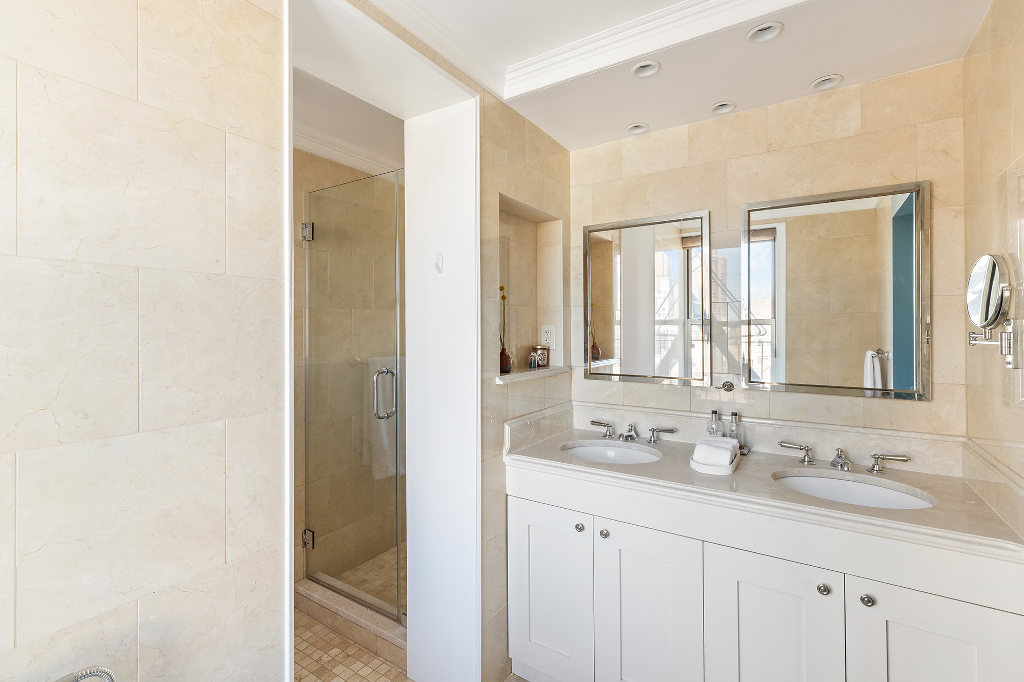 425 East 86th Street, Unit 11E Manhattan, NY 10028 - Photo 7 of 19 a bathroom with a sink double vanity and a mirror