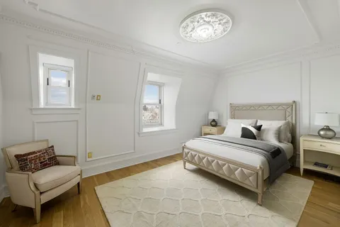 a bedroom with a bed and a couch