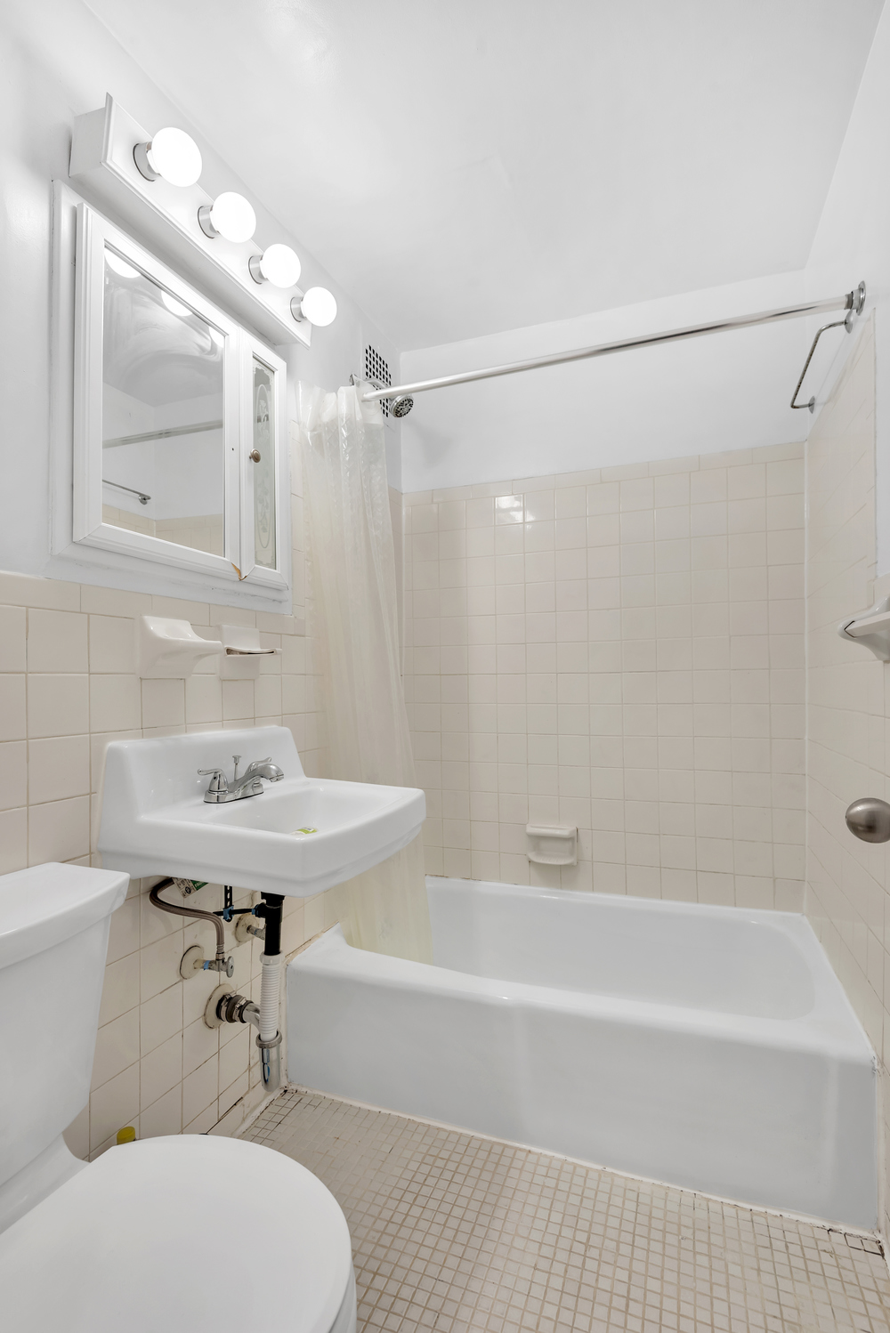 220 West 15th Street, Unit 1A Manhattan, NY 10011 - Photo 5 of 6 a bathroom with a sink a toilet and shower