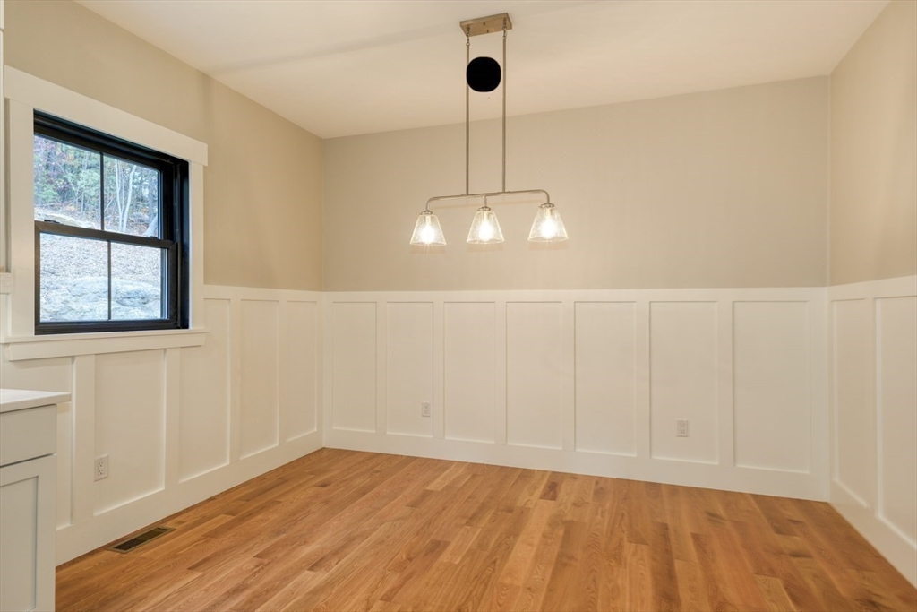 171 Randall Road Berlin, MA 01503 - Photo 11 of 41 a view of an empty room with wooden floor and fan