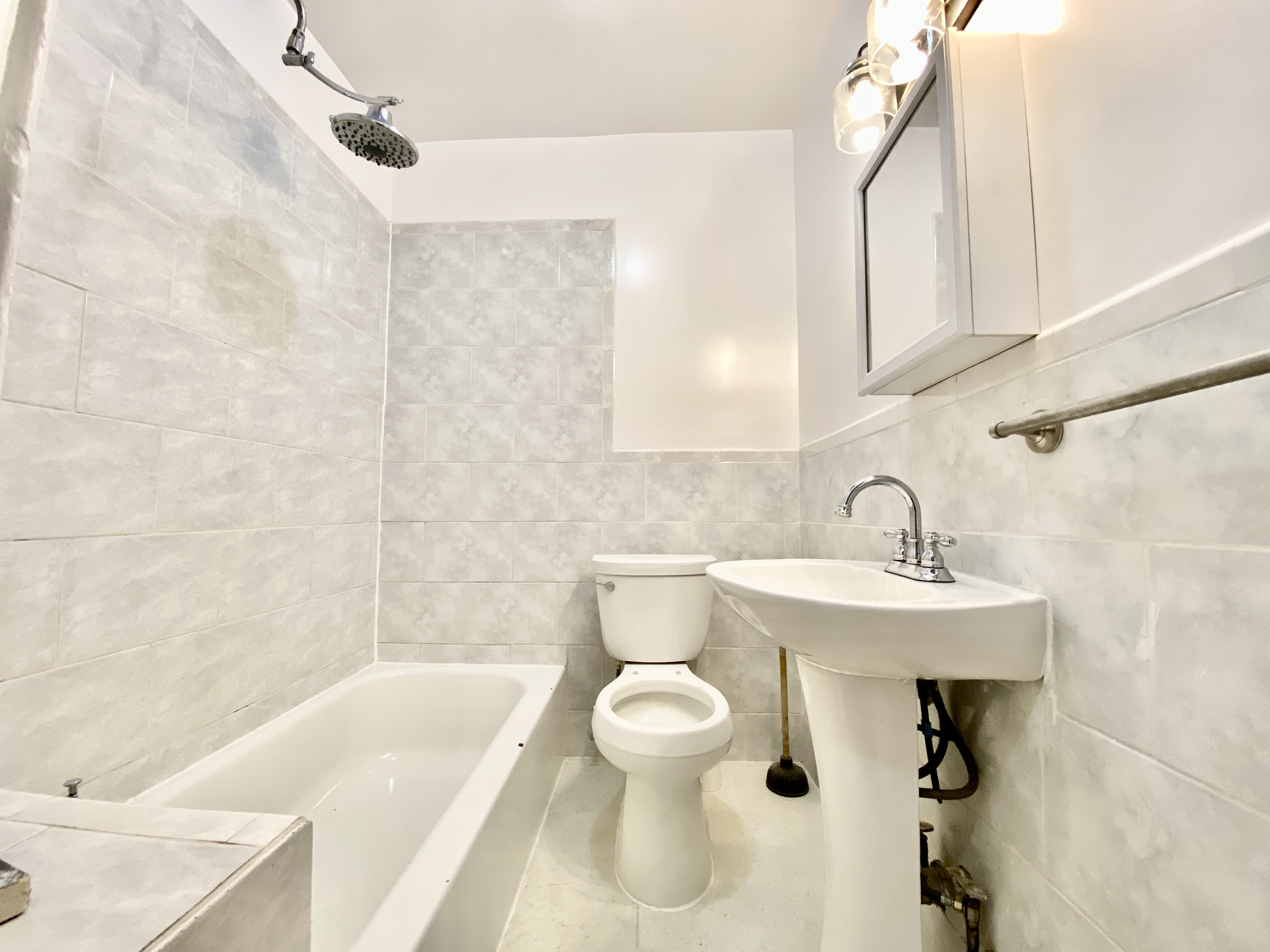 398 Decatur Street, Unit 3 Brooklyn, NY 11233 - Photo 8 of 9 a bathroom with a sink a toilet and a bathtub