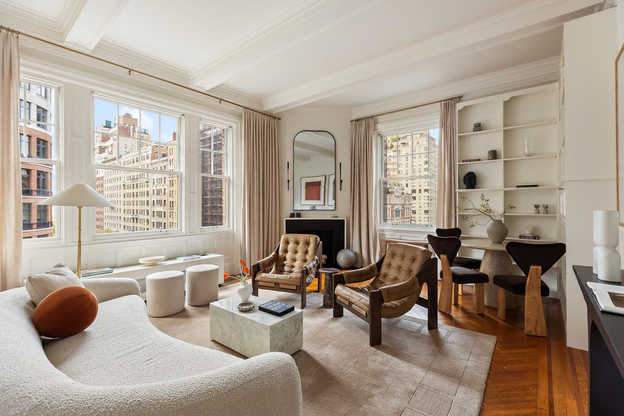 a living room with furniture and floor to ceiling windows